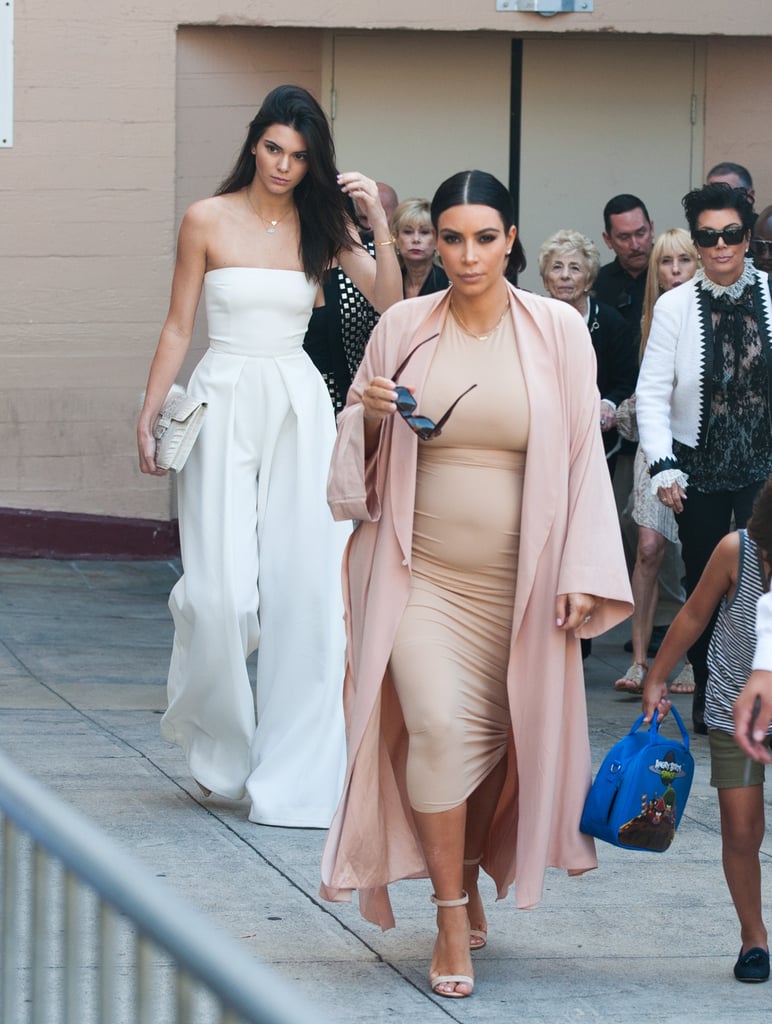 Kim chose a supertight sand-colored midi dress that matched her ankle strap sandals perfectly. She finished her outfit with a lightweight pink duster coat.