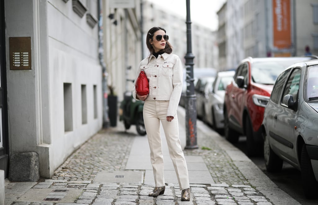 White denim head to toe feels edgy with Western boots and a bright bag.