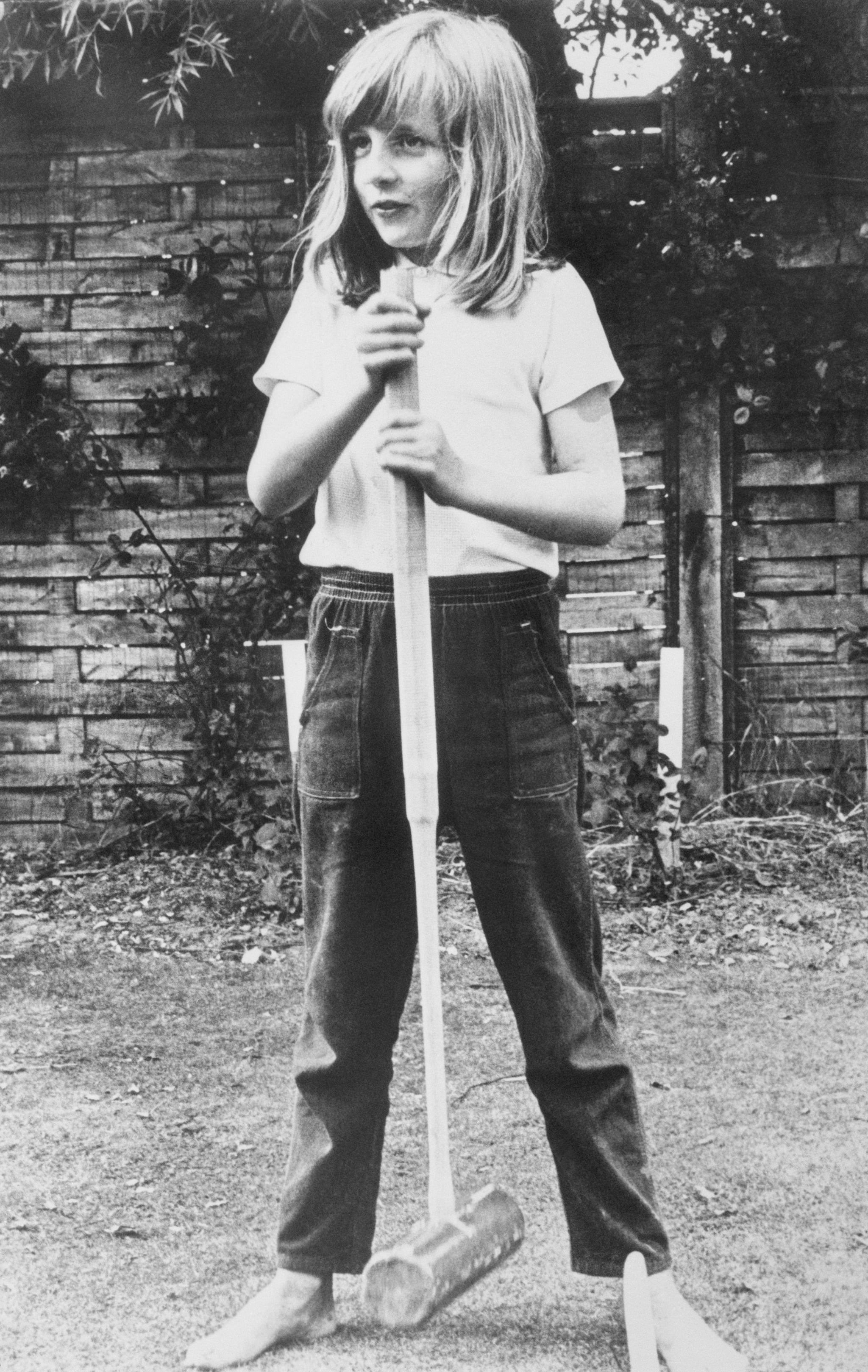 (Original Caption) Little Lady Diana. Itchenor, England: Lady Diana Spencer is to be 20 July 1. She and Britain's Prince Charles are to marry. In this picture, taken in summer, 1970, a barefoot Lady Diana poses with a croquet mallet while on holiday in Itchenor, West Sussex.