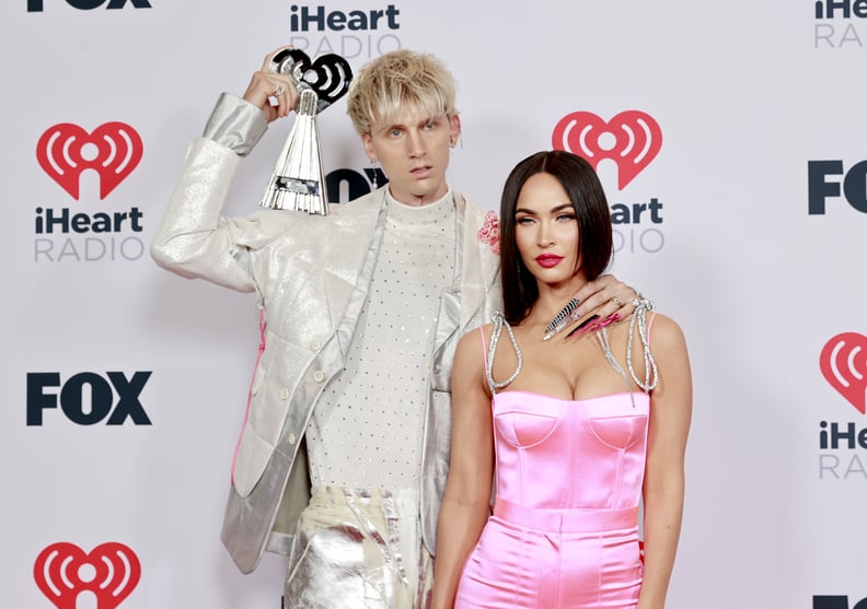 LOS ANGELES, CALIFORNIA - MAY 27: (EDITORIAL USE ONLY) (L-R) Machine Gun Kelly, winner of the Alternative Rock Album of the Year award for 'Tickets To My Downfall,' and Megan Fox attend the 2021 iHeartRadio Music Awards at The Dolby Theatre in Los Angeles