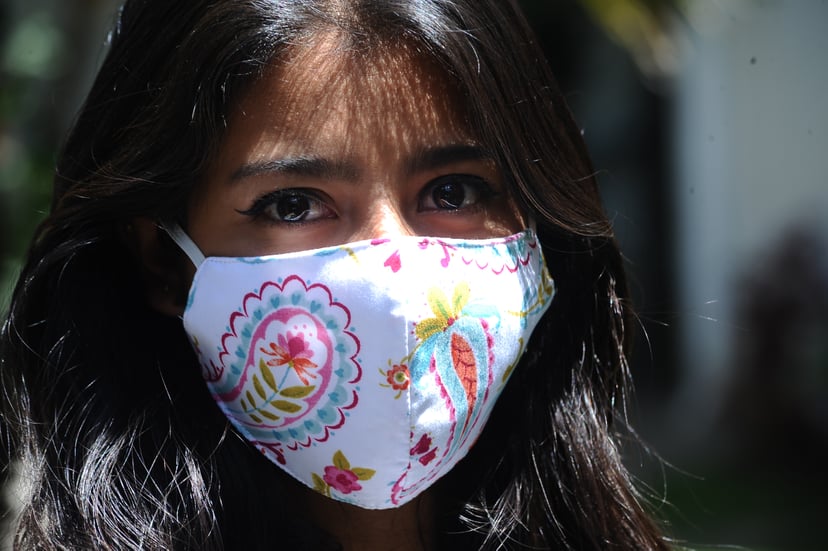 TLAXCALA, MEXICO - MAY 19, 2020: Maria de Lourdes Galindo, originally from Huamantla wears face mask while manufacturing a protective mask as an attempt to prevent Coronavirus desease , she worked in the clothing customization but due to coronavirus pande