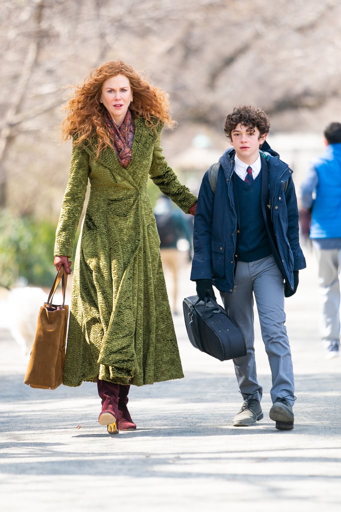 The skirt of the coat is quite full, which makes for some eye-catching moments as Grace power walks through Manhattan. Here she carries it with a brown suede Métier London purse.