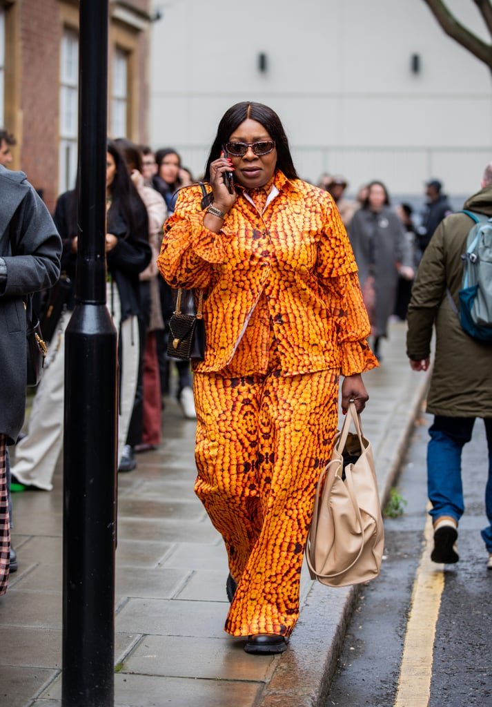 The Afro-futurist print of this orange coordinated set pairs perfectly with neutral accessories.