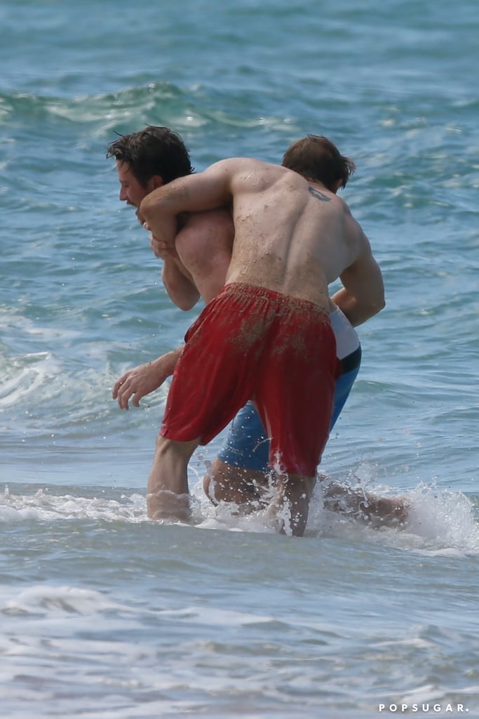 Charlie Hunnam and Garrett Hedlund Wrestle in Hawaii Photos