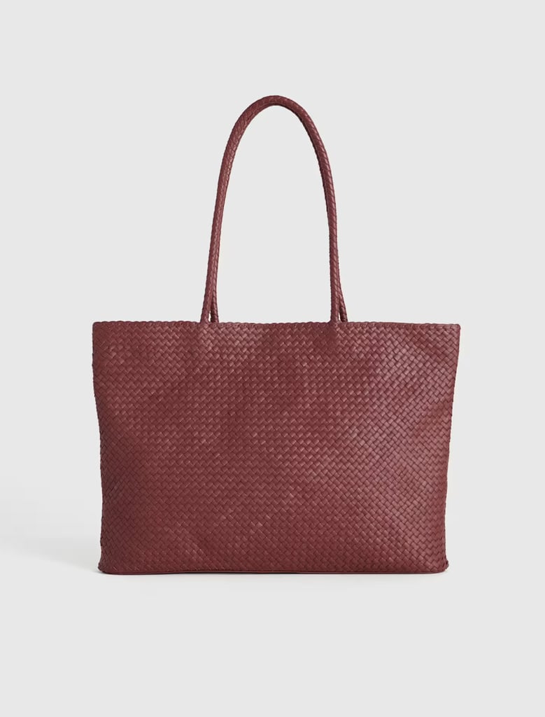 Quince Italian Leather Handwoven Tote ($150)
Wine is one of the most popular colors this summer, and Quince's Italian Leather Handwoven Tote is a great way to hop on the trend. It's eye-catching yet classic thanks to its handcrafted fabrication and oversize look. It also includes a spacious interior with a zippered pocket and two slip pockets, making it practical for all your upcoming travels.