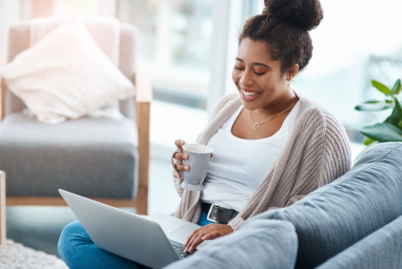 Cropped shot of an attractive young woman using her laptop to make a video call at home