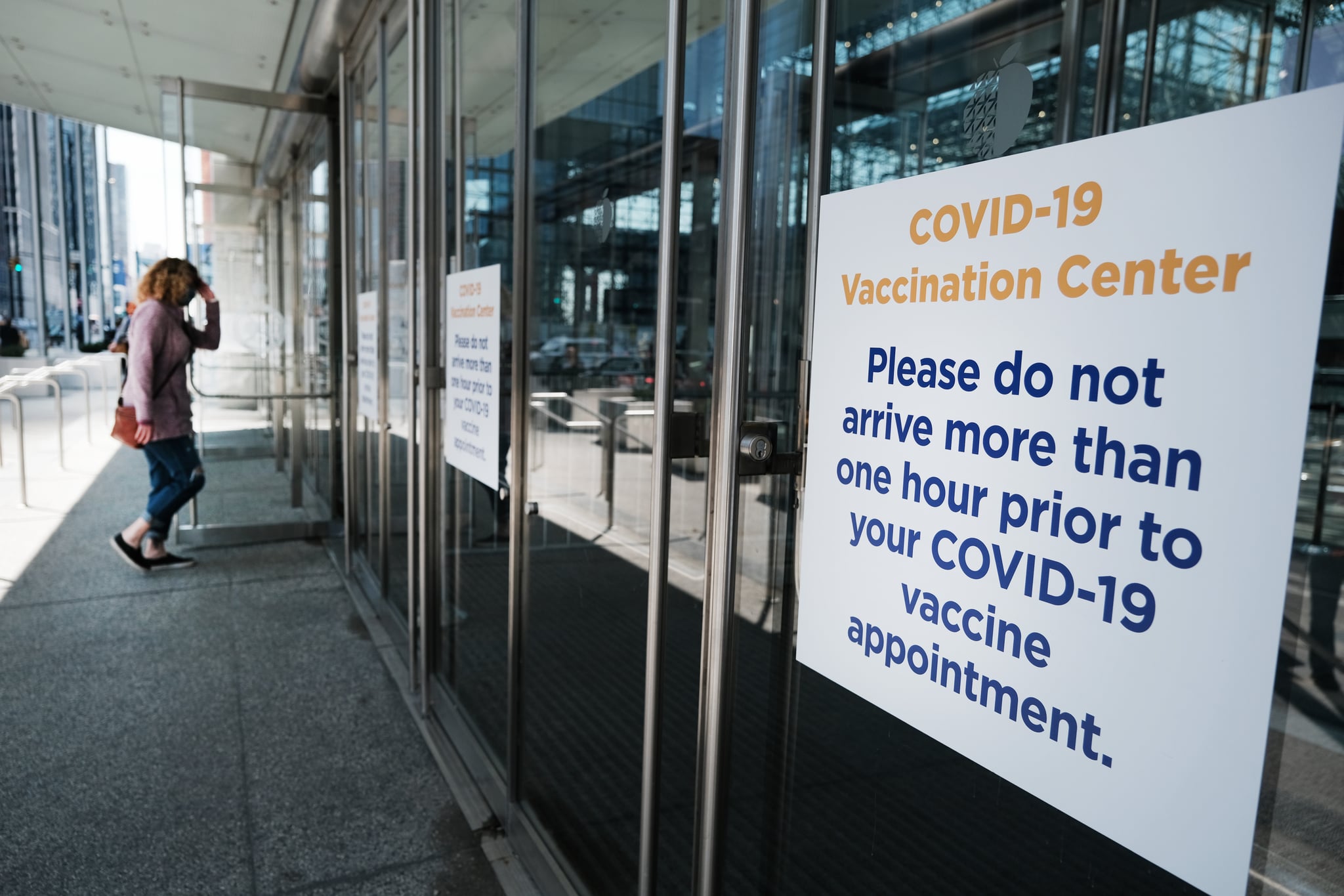 NEW YORK, NEW YORK - MARCH 23: People enter and exit the Javits Center Covid-19 vaccination site on March 23, 2021 in New York City. As New York City slowly re-opens, Governor Andrew Cuomo announced that starting Tuesday residents ages 50 and up will be eligible to get the COVID vaccine. (Photo by Spencer Platt/Getty Images)