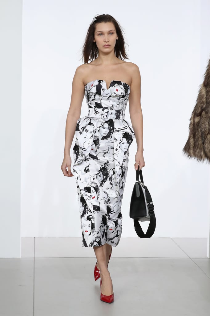 Walking in Michael Kors wearing a strapless graphic-print dress.