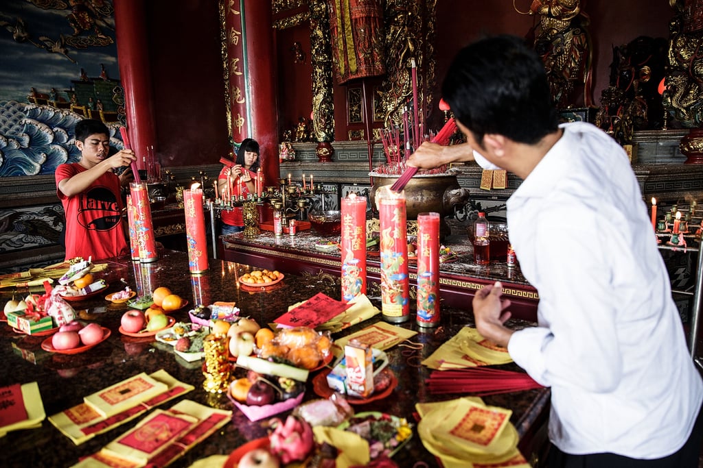 A man burned incense at the Satya Dharma Temple in Bali.