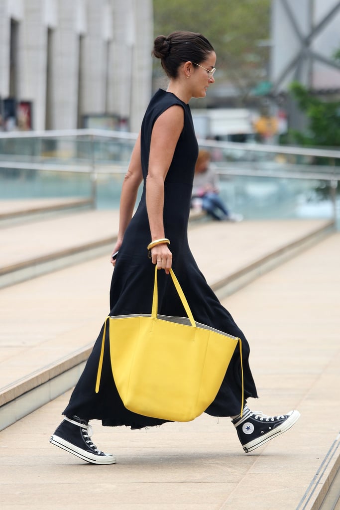 Add a bold pop of color, by way of a canary yellow tote, to an all-black dress.