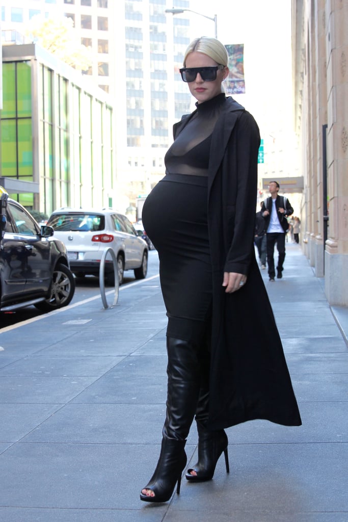 I kept my chest covered with the coat as I walked through the office down to the street, but once I got outside, I had no qualms about baring my black undergarment since I felt so modestly dressed otherwise. I must say, Kim's duster coats are actually genius. They hide the butt, which inevitably grows while you're growing a human, and make the skin-tight, often sheer ensembles feel a lot less revealing. 
I actually felt more self-conscious walking through my office full of gawking (and extremely encouraging) co-workers than I did on the street being stared at by strangers (maybe due to the fact that half my face was hiding behind huge dark sunglasses a la Kim?). 
So, my first step into Kim K's shoes wasn't that bad — well, it was pretty comical walking in five-inch platform over-the-knee, open-toe boots while trying to balance my expanding stomach — but otherwise, not that bad.