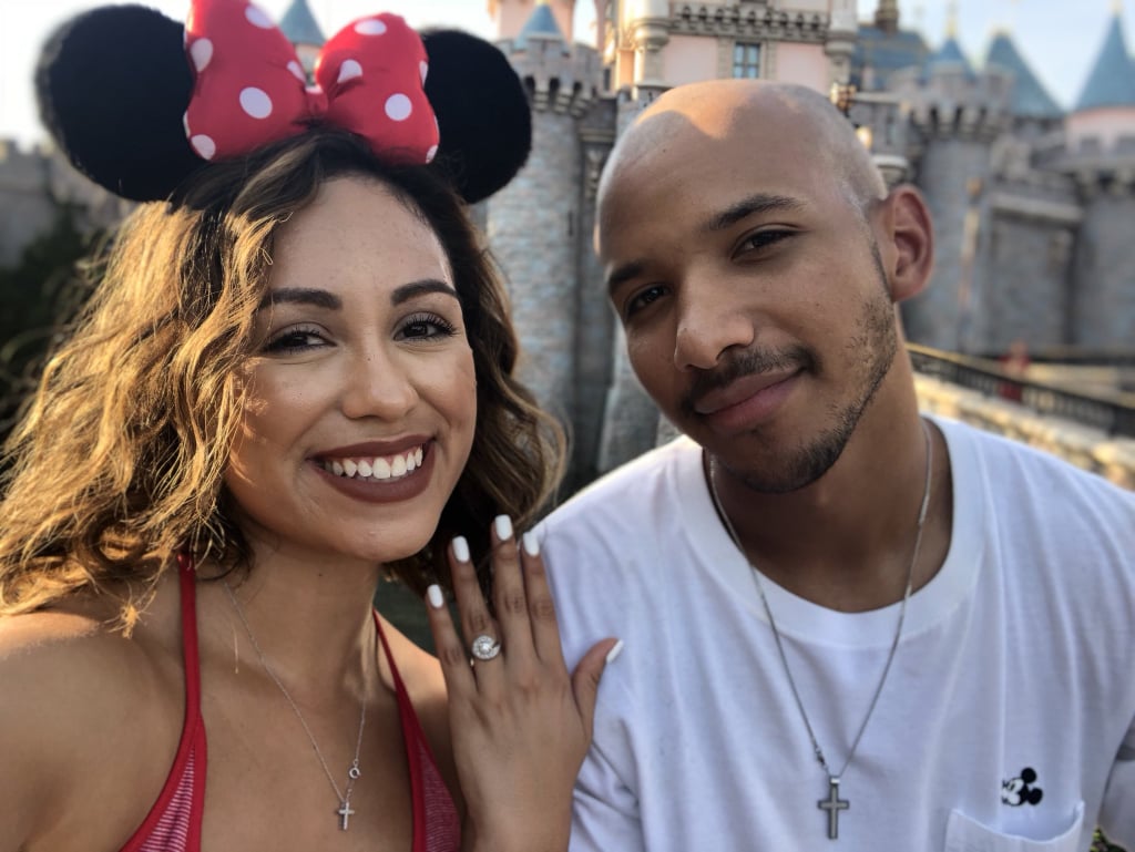 The newly engaged couple in front of the castle.
