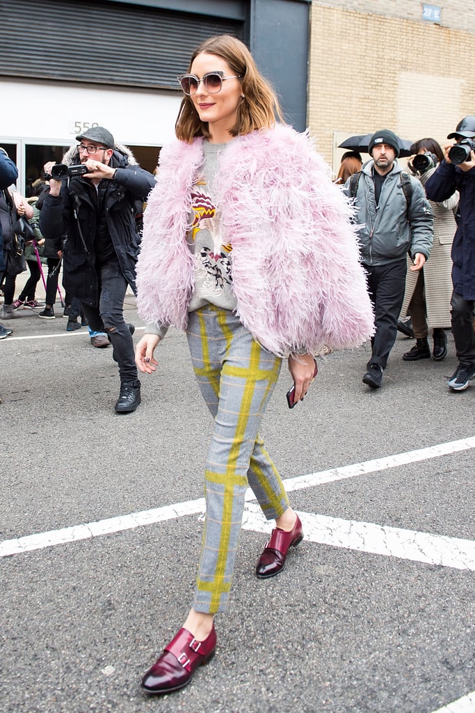 Making her way to the Ralph Lauren show, Olivia wore a sweater and trousers by the brand. She topped the look off with a Cinq á Sept marabou jacket and Satoni loafers.