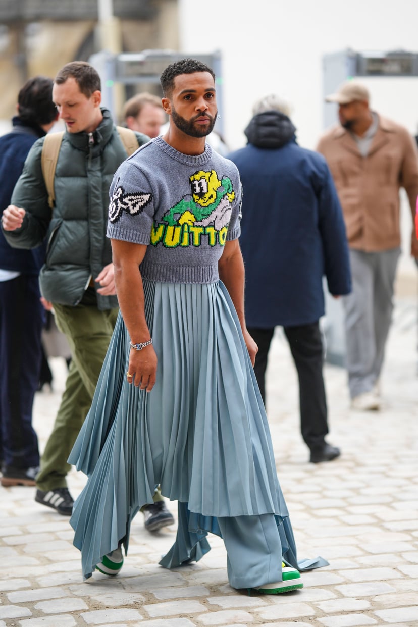 Lucien Laviscount makes quite the entrance in a blue pleated skirt
