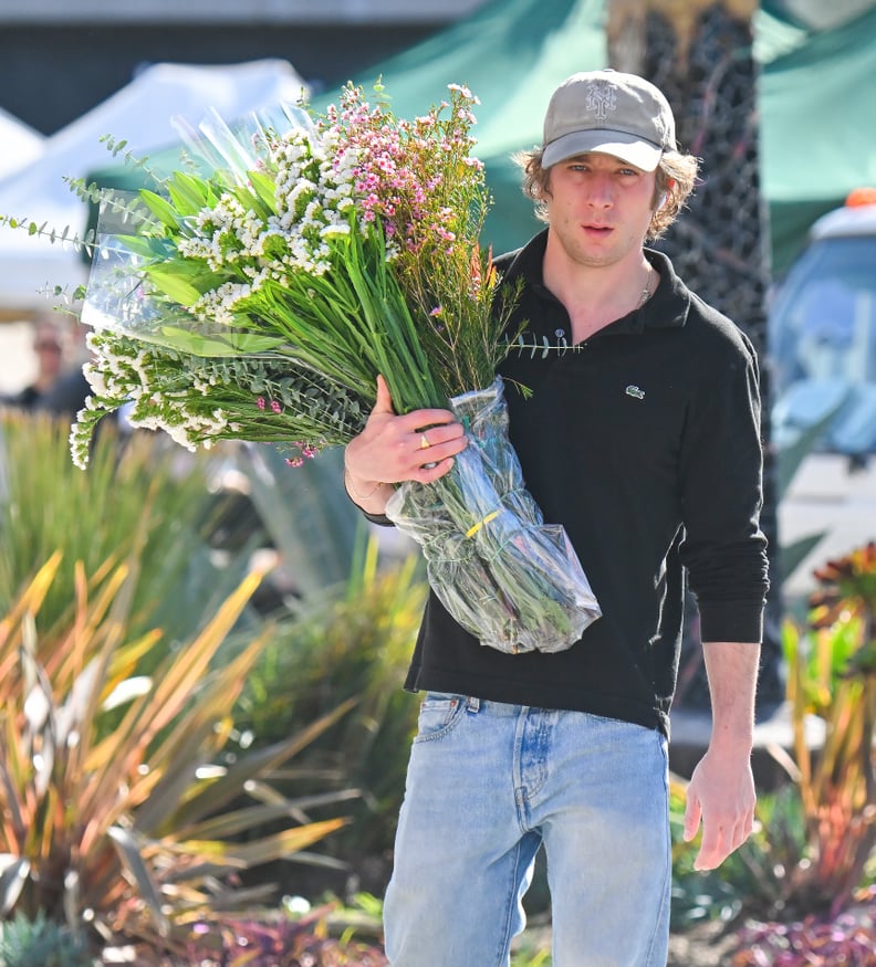 Jeremy Allen White carrying flowers