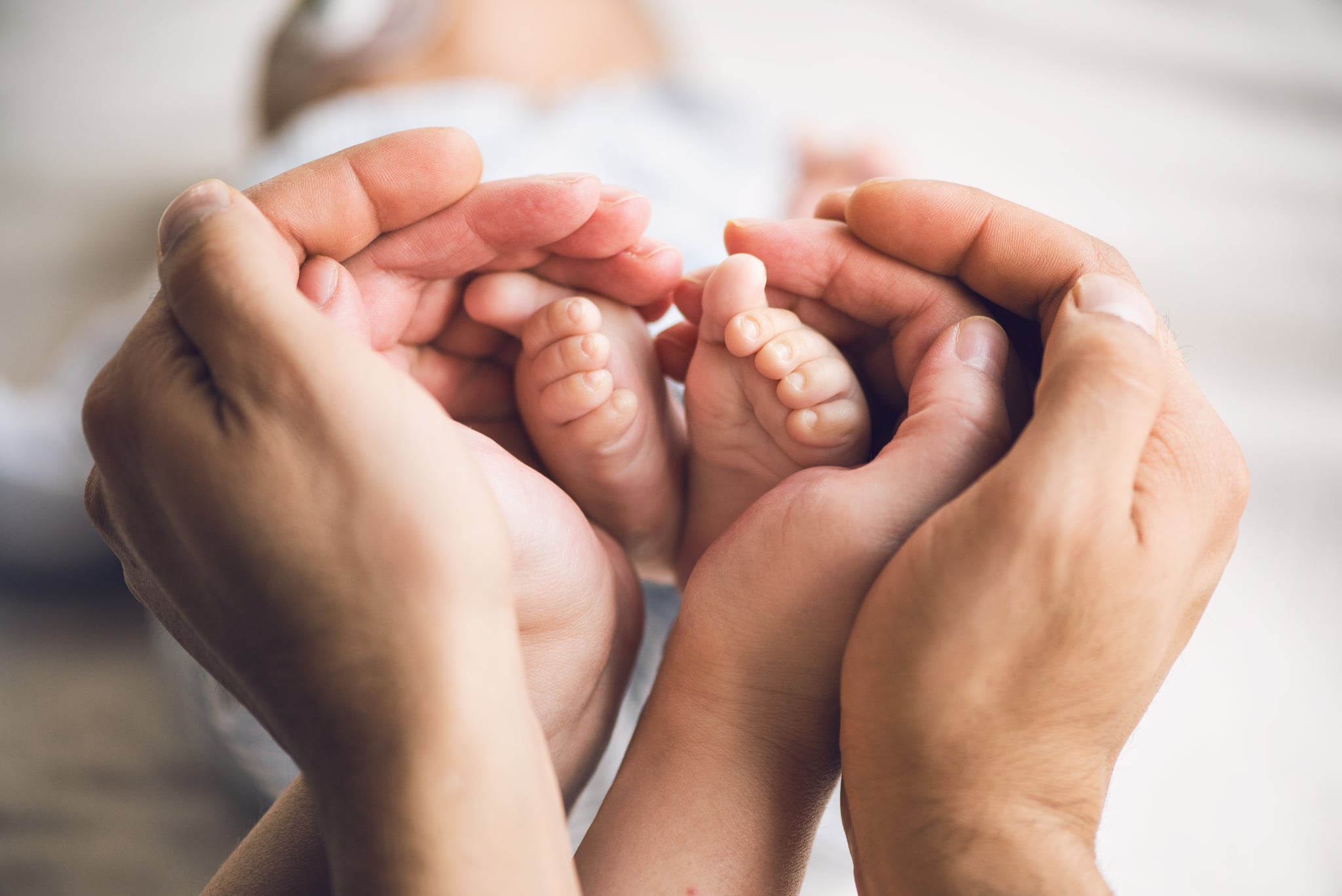 Little baby feet in parents hands
