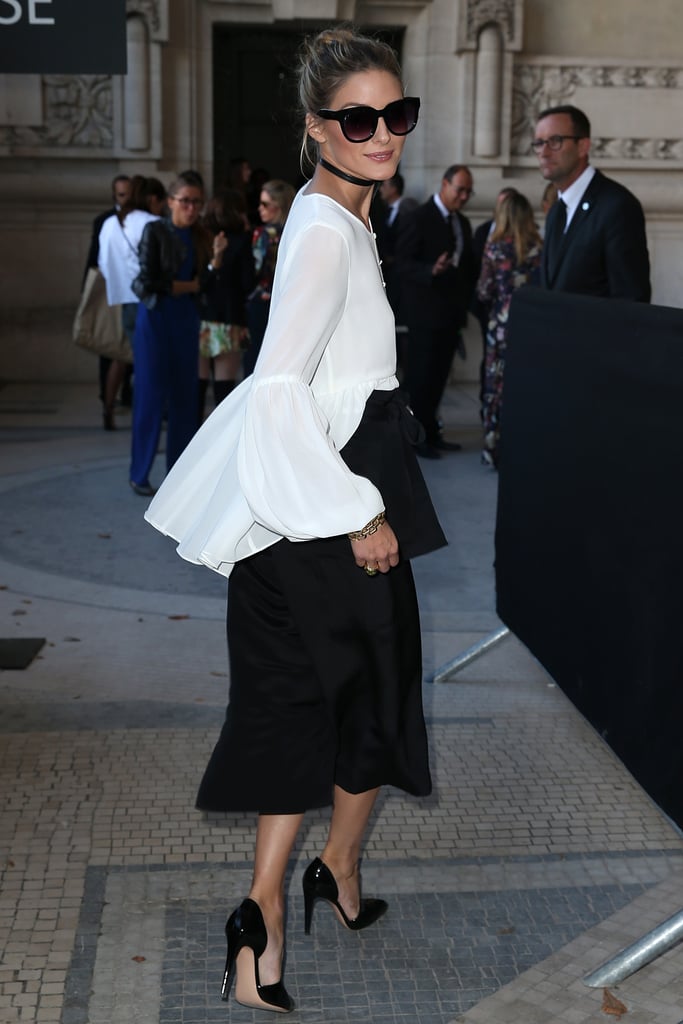 Olivia tucked a flowing peplum L'Academie top into black culottes for a dramatic effect while out at Paris Fashion Week.