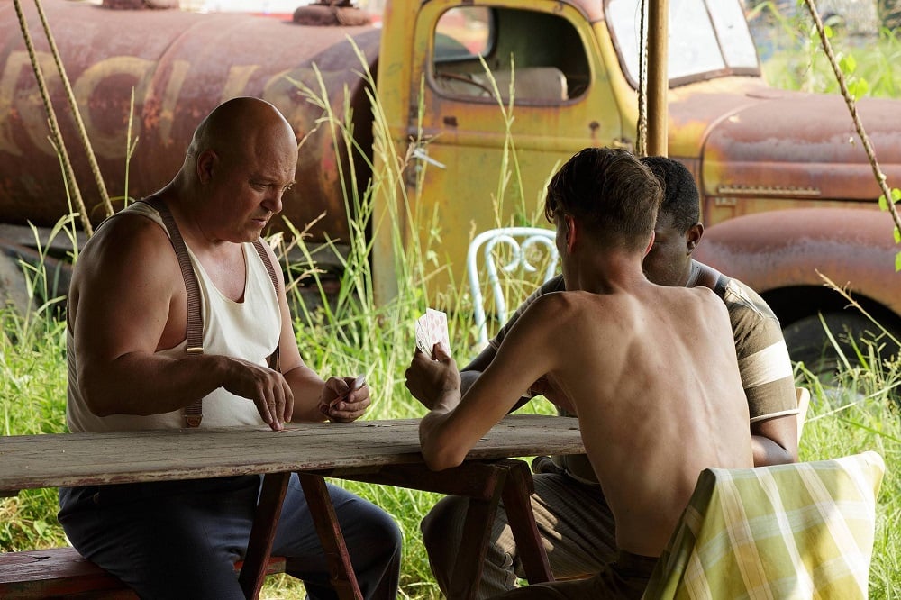 The freaks play cards to pass the time.