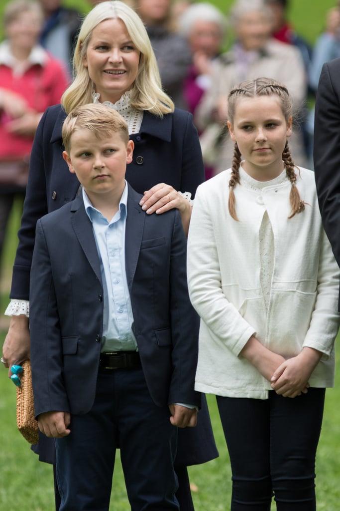 Princess Mette-Marit rested her hand on her son's shoulder while at a park opening in 2016.