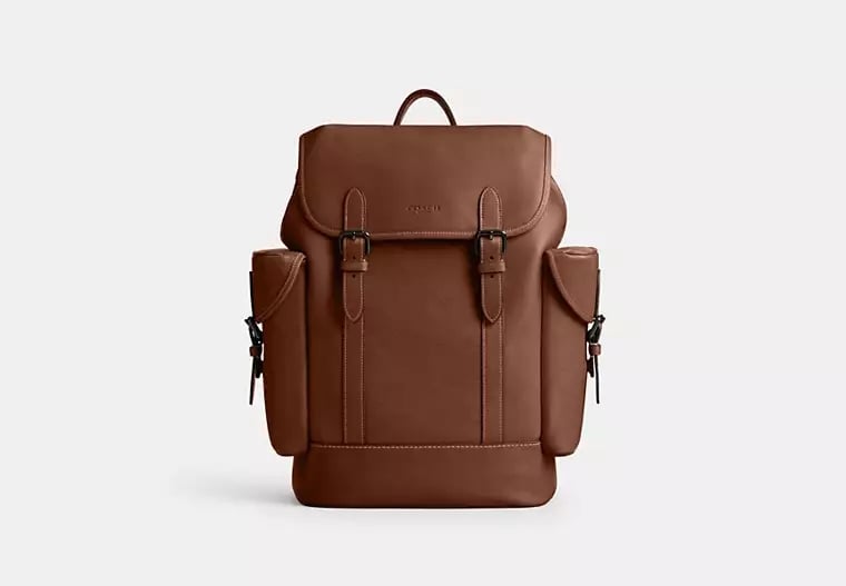 Coach Hitch Backpack ($595)  
Consider this proof that really anything can be a gym bag. If your busy schedule demands your baggage to take you from the boardroom to the weight room, invest in a high-end design such as this Coach backpack. Still offering plenty of storage, you'll maintain a professional and sleek finish.
Pros: The magnetic clasps make it easy to open and close
Cons: A closed backpack can limit how much you can pack
Material: Canvas and leather
Dimensions: 16.5" H x 5.75" W x 12.25" L
Colorways: One
Who It's Best For: Going from the gym to the office 
What Reviewers Say: "I love how spacious this bag is. It's good for travel, a day trip, or an overnight. It can fit two set of clothes, a pair of shoes, chargers, and a makeup bag."