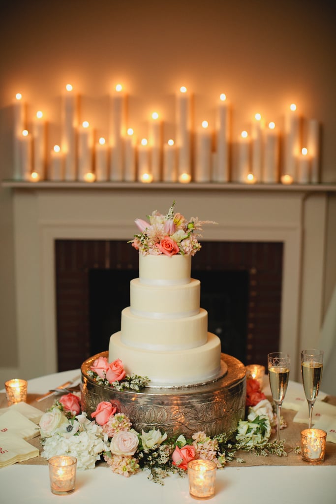 This is the perfect example of how you can take a plain tiered cake and turn it into a dessert with flair. Here, the extra details — the stand, the candles, the flowers — make it stand out, but it could just as easily look great without them.