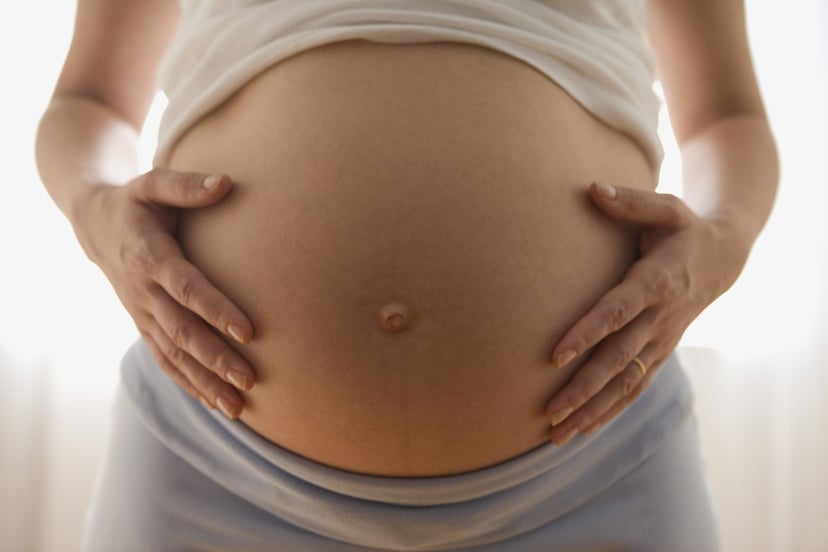 Pregnant women holding belly