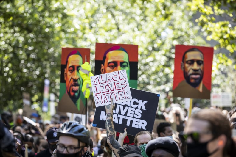 MANHATTAN, NY - JUNE 19:  A protester with tattoos holds a sign that says,