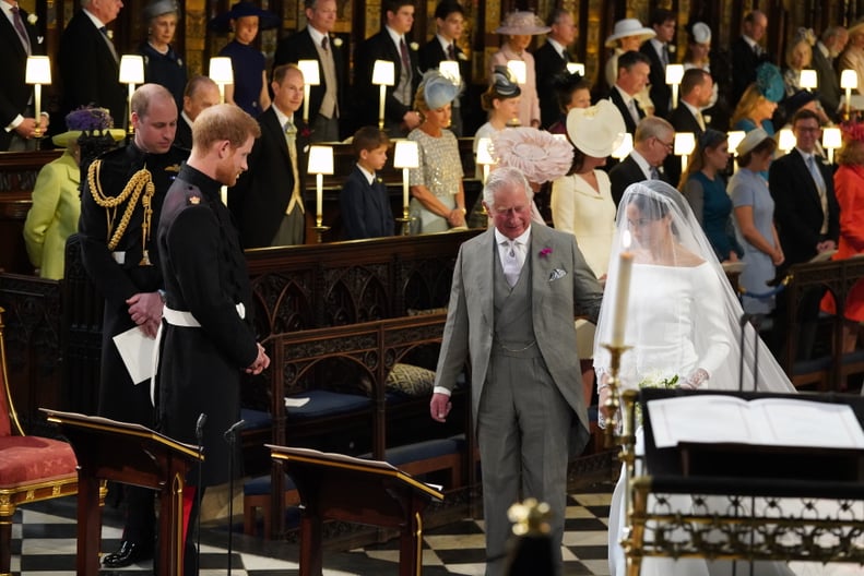 WINDSOR, UNITED KINGDOM - MAY 19:  Prince Harry looks at his bride, Meghan Markle, as she arrives accompanied by Prince Charles, Prince of Wales during their wedding in St George's Chapel at Windsor Castle on May 19, 2018 in Windsor, England. (Photo by Jo