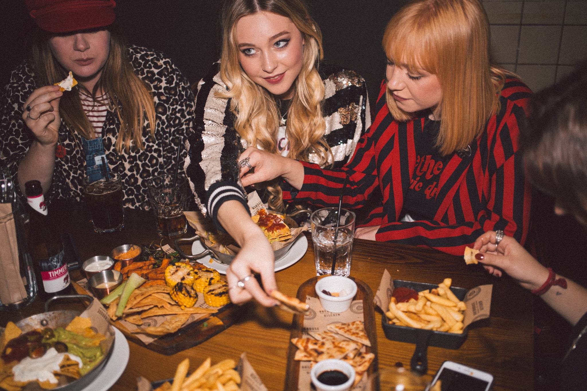 Young ladies enjoying a fun night out together. Eating at a restaurant and catching up