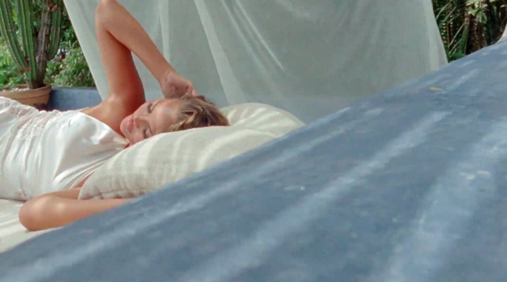 Chrissy Teigen Reveals Pregnancy in a White Dress in "Wild"