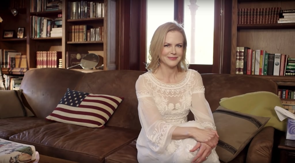 To the other side of the entryway, there's a living room with a brown leather couch that matches the bookcases along the walls. On the couch is an American flag pillow, a nod to Keith Urban's country music career and to the couple's other home in Nashville.