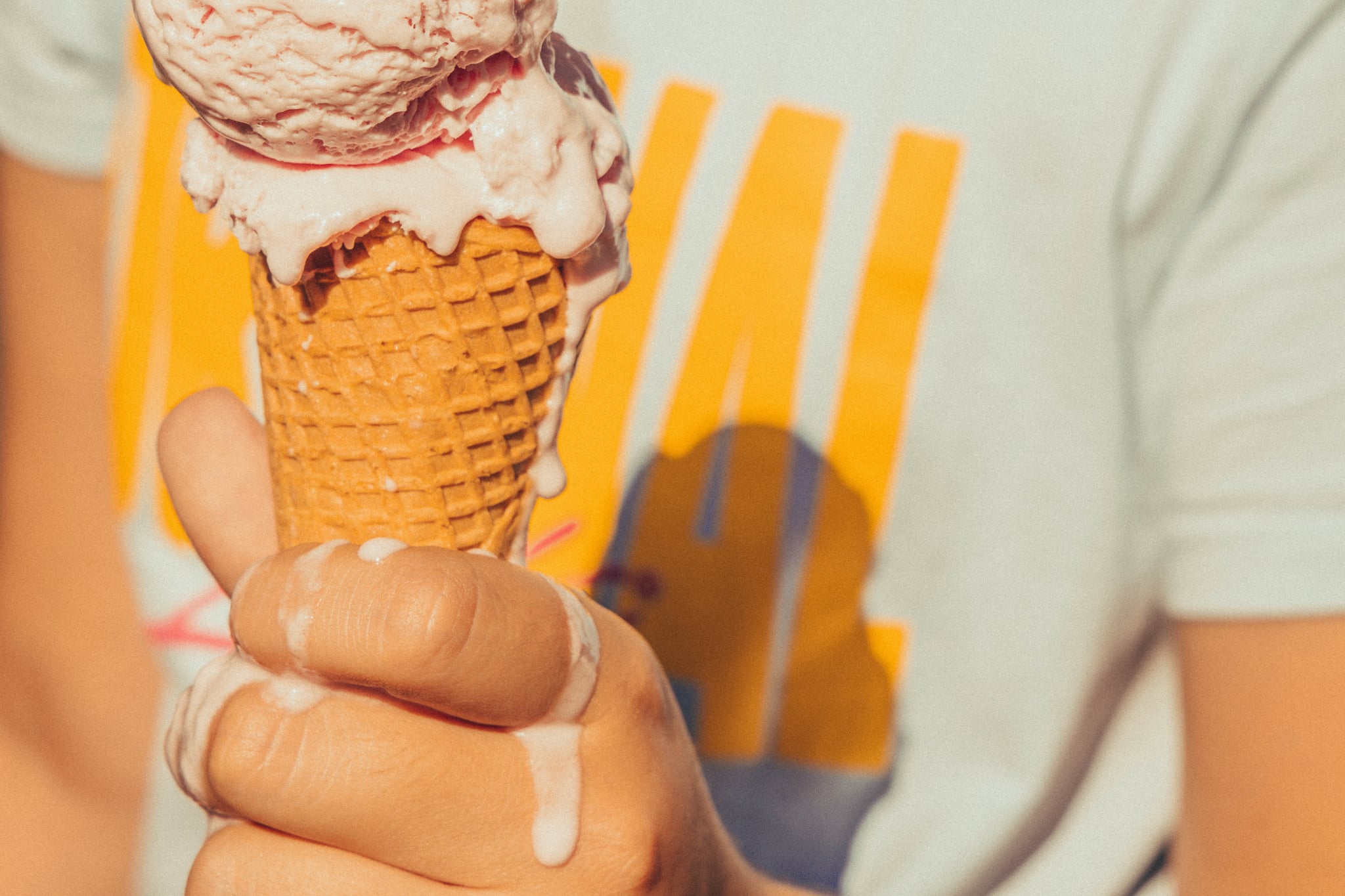 person eating dripping ice cream cone thanks to national ice cream day deals