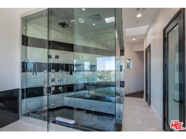 The master bathroom includes a steam shower, sauna, and infinity tub with views overlooking Beverly Hills. Talk about luxury.