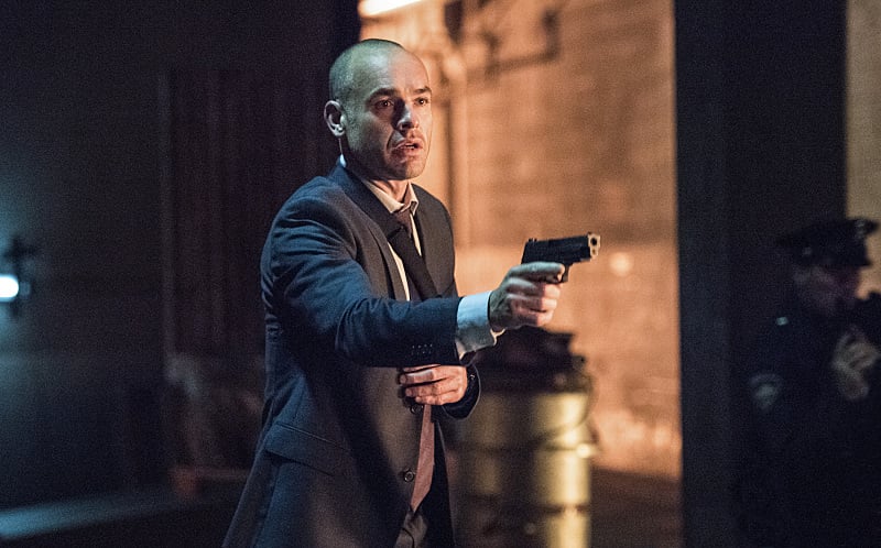 Oh no! Detective Lance (Paul Blackthorne) doesn't look too hot.