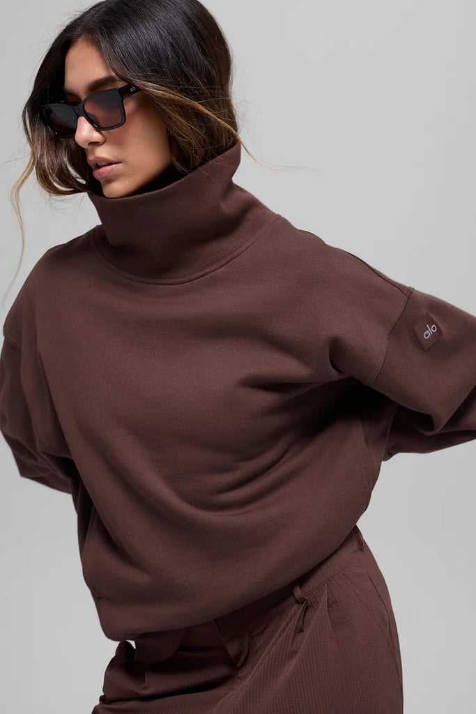 Alo Yoga Hazy Mock Neck Pullover ($138)
If you want the sophisticated look of a turtleneck but the comfort and ease of a sweatshirt, then a mock-neck pullover will be your favorite find. Available in over nine colors, this trendy silhouette will elevate your commute to the gym during colder months.