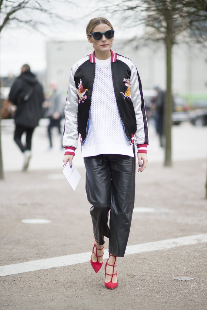 Between shows, Olivia was caught in a Tibi sweater and leather pants, which she completed with a Topshop jacket and red Louboutins.