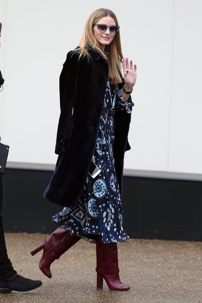 For Burberry, the style setter worked an overcoat layered up over her printed Burberry dress and cranberry boots.