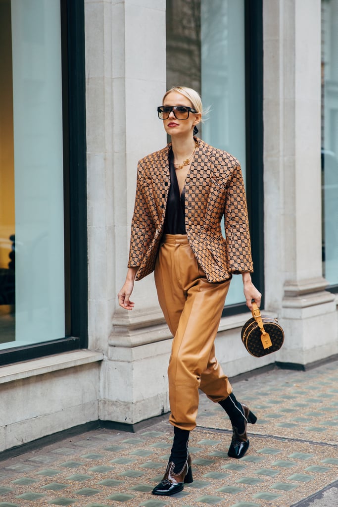 Tuck tapered leather trousers into a slick sock bootie.