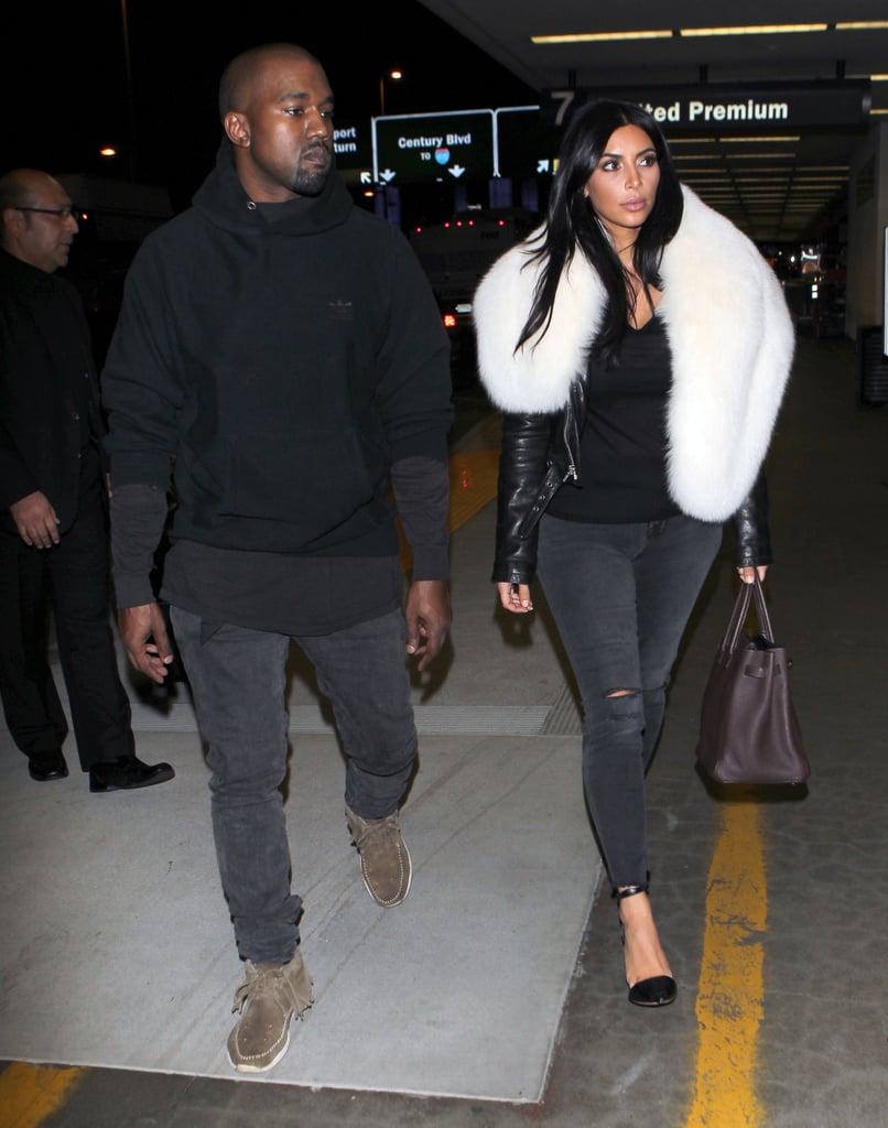 Kanye West and Kim Kardashian stayed close at LAX on Wednesday.