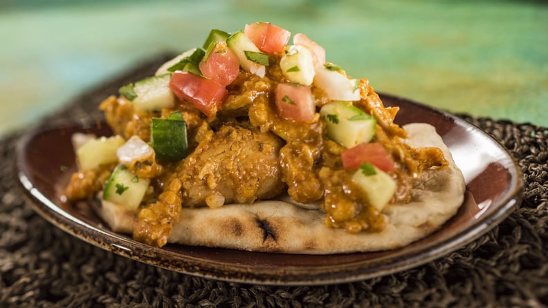 India:  Korma Chicken With Cucumber Tomato Salad, Almonds, Cashews, and Warm Naan Bread