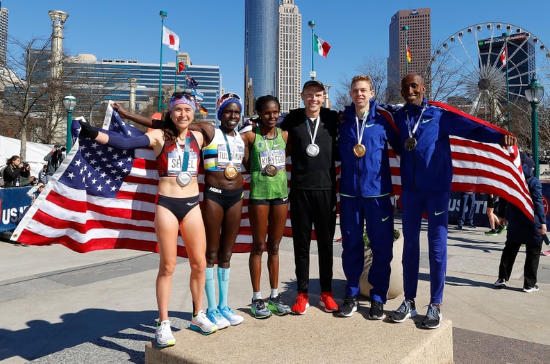 ATLANTA, GEORGIA - FEBRUARY 29:  (L-R) Molly Seidel, Aliphine Tuliamuk, Sally Kipyego, Jacob Riley, Galen Rupp, and Abdi Abdirahman pose together after finishing in the top three of the Men's and Women's U.S. Olympic marathon team trials on February 29, 2