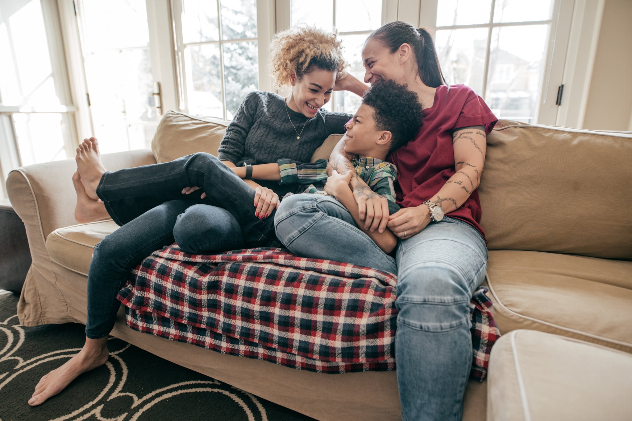 A lesbian couple hanging out with teen son.