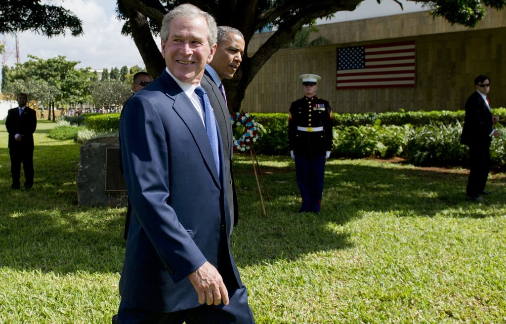 In July 2013, former President George W. Bush smiled next to President Obama as they arrived at the wreath-laying ceremony for victims of the 1998 US Embassy bombing in Tanzania.