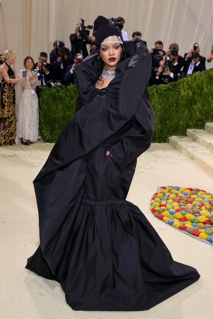 Leave it to Rihanna to arrive at the Met Gala after the red carpet wraps . . . and still make a splash. The multihyphenate and Met Gala legend showed up fashionably late in a look we can only describe as parka couture. Truly unlike anything else worn during the night, her puffy Balenciaga gown features a floor-sweeping, fluted train, as well as an exaggerated collar, all in a nylon parka material.
She appropriately topped off the look with a matching black beanie, with a stunning jewelled headband peeking from underneath it. She also accessorised with Bvlgari diamond necklaces, bracelets, and an earring amounting to over 267 carats, in addition to a diamond ring from Thelma West and custom Maria Tash earrings. Rihanna posed on the Met red carpet alongside boyfriend A$AP Rocky, who also wore an oversized parka, but in a patchwork print. Get a closer look at the billionaire businesswoman's dramatic gown ahead. 

    Related:

            
            
                                    
                            

            Rihanna Is Already Letting People Know She&apos;s Throwing the Superior Met Gala Afterparty