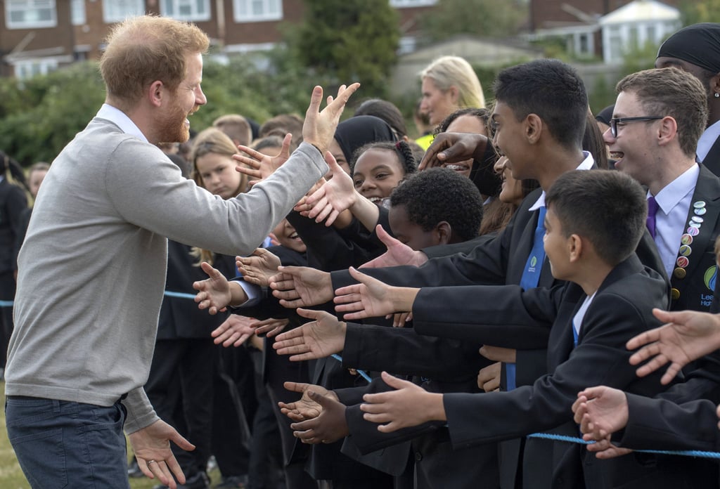 Prince Harry Hugs Kids at Lealands High School