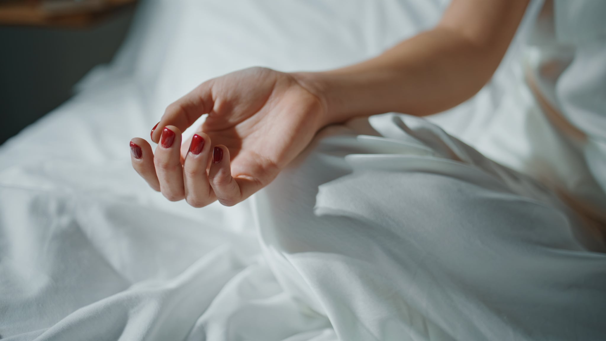 Closeup hands on bed 