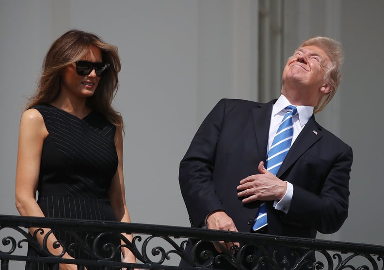 Trump doesn't even try to cover his eyes as he stares into the sky.