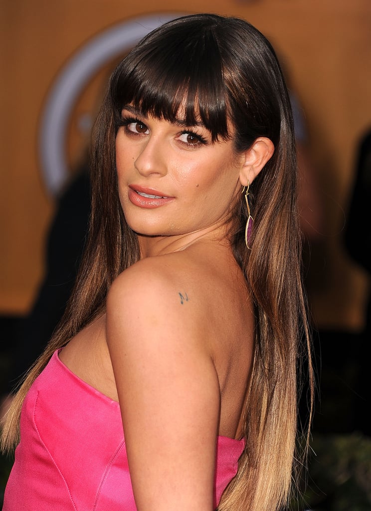 On her left shoulder lie musical notes from Queen's "Bohemian Rhapsody."