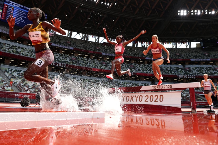 TOKYO, JAPAN - AUGUST 01:  Peruth Chemutai of Team Uganda, Winfred Mutile Yavi of Team Bahrain and Emma Coburn of Team United States compete in round one of the Women's 3000m Steeplechase heats on day nine of the Tokyo 2020 Olympic Games at Olympic Stadiu