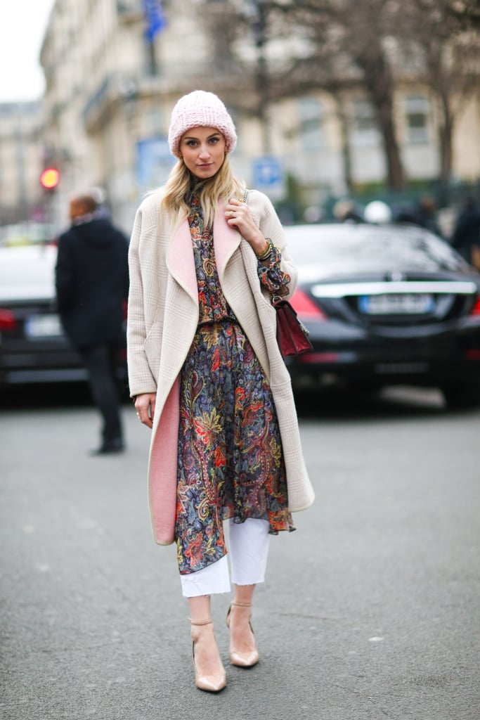 Instead of wearing your dress with blue denim, switch it up with a white pair. This street style star made it look effortless with her paisley-printed dress and plaid coat.